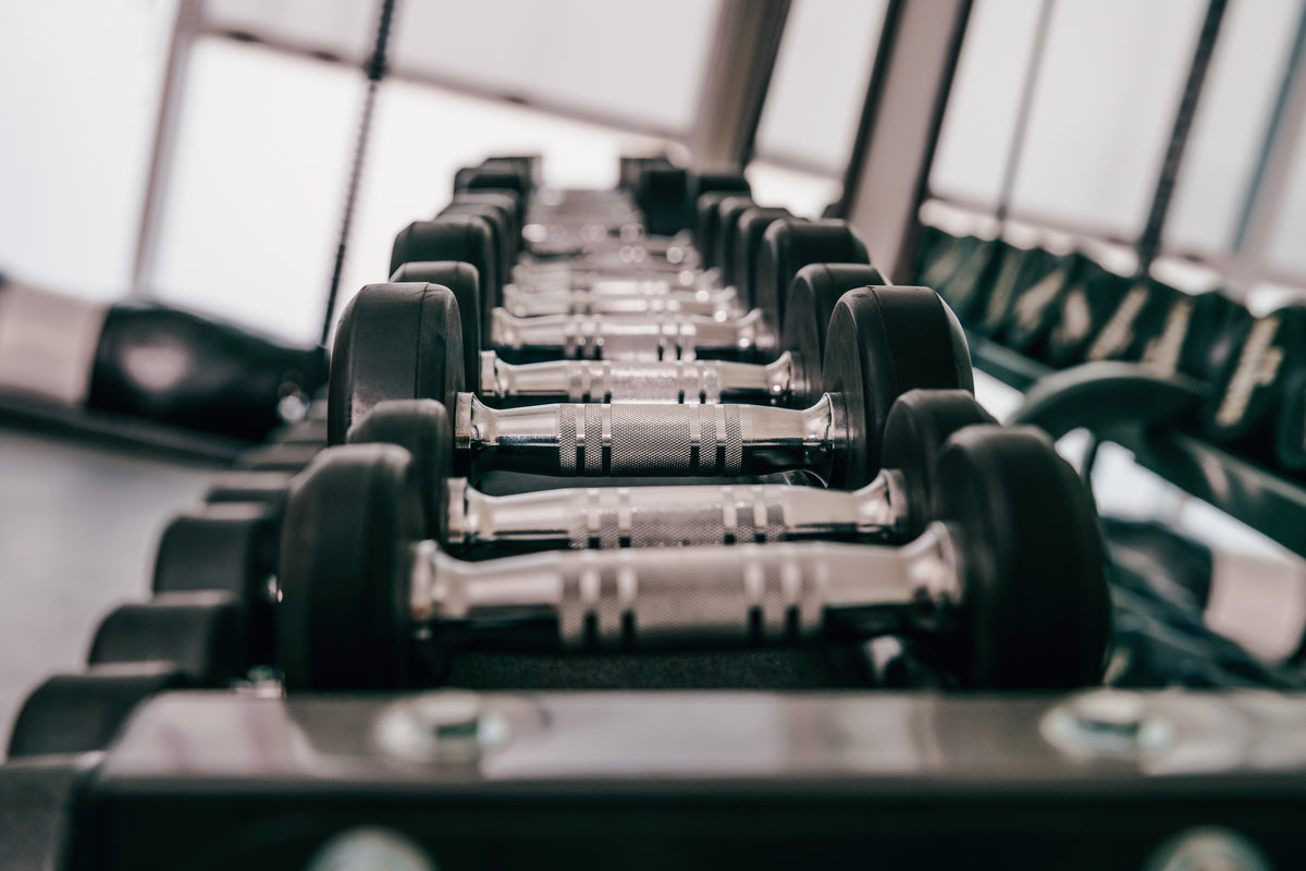 A rack of free weights in a training gym